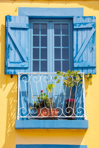 istock blue and yellow painted wooden window 1911680939