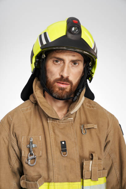 istock Exhausted firefighter in helmet tiredly looking at camera. 1911683764