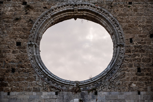Destroyed window rosette at the abandoned Cistercian monastery San Galgano in the Tuscany, Italy