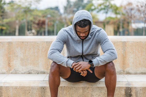istock Sad black sportsman resting after training 1911704652