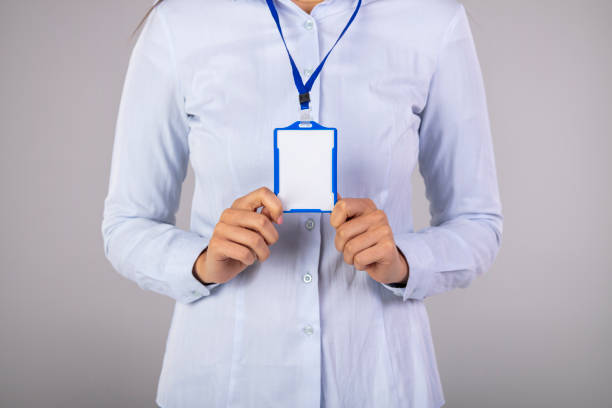 istock Woman holding Identification white blank plastic id card. 1911727207