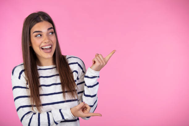 istock Amazement, wondered woman pointing finger right, at copy space. 1911731854