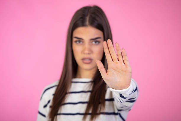 istock Woman giving a halt or stop gesture 1911732381