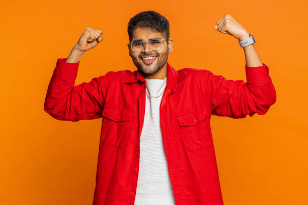 istock Man looking confident showing biceps, feeling power strength to fight for rights, success win 1911738928