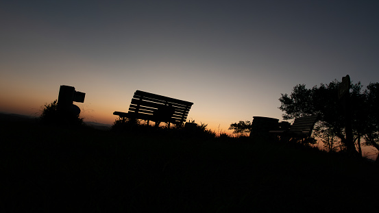 Beautiful sunset and silhouette of bench