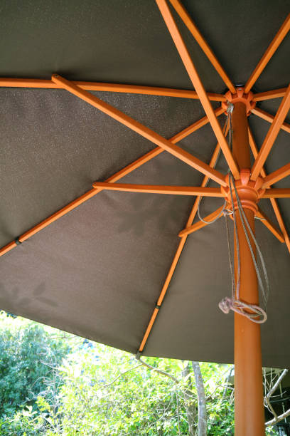 istock Chocolate Brown Patio Umbrella in the Garden 1911749685