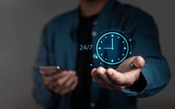 istock Businessman holding 24-7 with clock on virtual interface for worldwide nonstop and full-time available contact of service. Nonstop customer service concept. 1911749702