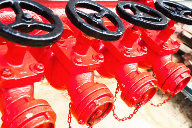 four red fire hydrants on a fire line on a ship. - pipeline sea flange water - fotografias e filmes do acervo