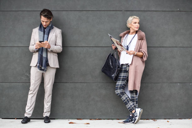 istock Man and woman on a bus station 1911752340