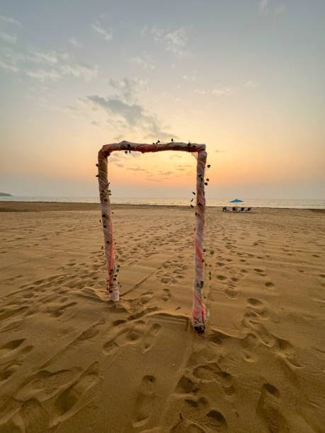 istock Beautiful beache lights stand and foot print sunset 1911766942