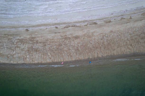 istock Vertical bird's-eye view of seawater and beach 1911771717