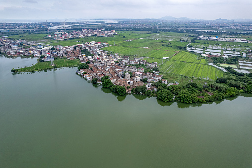 An aerial view of the village houses and farmland by the lake