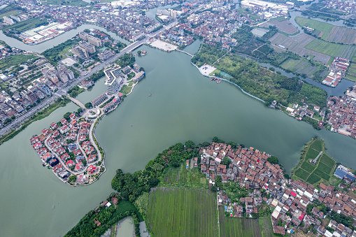 An aerial view of the village houses and farmland by the lake