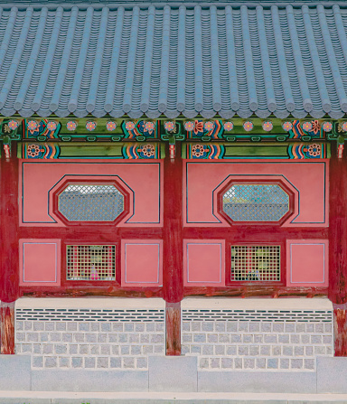 Front view of tile roof and Dancheong on the wall of Gyeongbokgung Palace, Seoul, South Korea. Close-up shot of the details of the Korean traditional Palace walls. Beautiful korean style wallpaper.