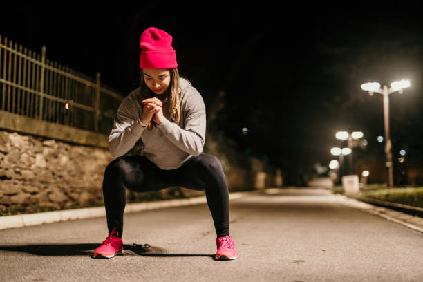 istock young woman exercising at night 1911840948
