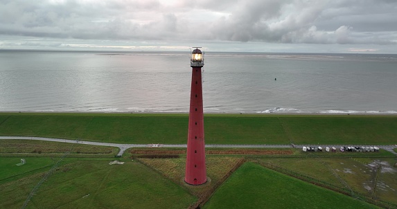Lighthouse tower Lange Jaap in Den Helder drone aerial footage 5K along the sea near the island of Texel in North Holland, The Netherlands. Aerial