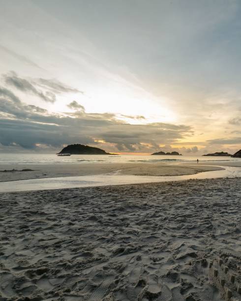 istock beach sand reflecting the rising sun. sandy beach with watery textures. 1911887934