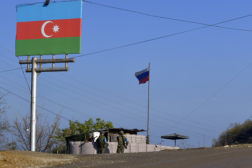 Susha, Nagorno Karabakh, Azerbaijan: check-point manned by armed Russian peacekeepers, soldiers or the 15th Separate Motor Rifle Brigade of the Russian Ground Forces - Azerbaijani and Russian flags. Russian army monitoring the ceasefire between the Armenian and Azerbaijani forces.
