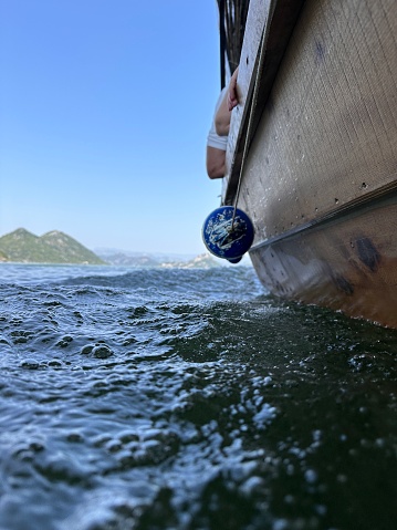 A close-up of the bow of a ship sailing in calm waters