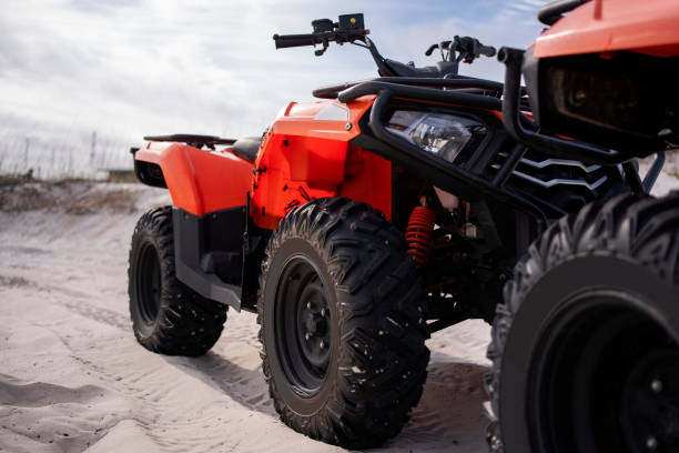 Driving on a dusty road through the forest. Enjoying a quad bike ride