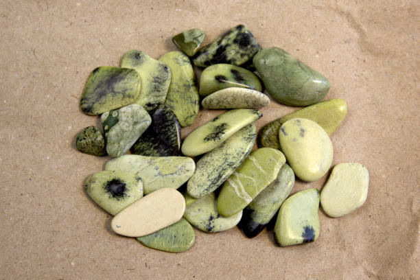 istock Set of stones Serpentinite mineral on paper background 1911987501