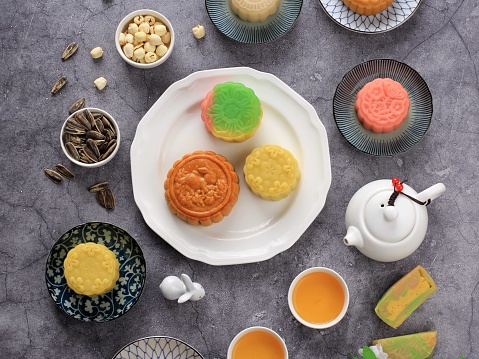 Selected Focus Concept Various Mooncake, Traditional and Colorful Snow Skin Moon Cake, Dessert for Mid-Autumn Festival on Stone Background, Close up, Lifestyle.