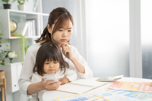 istock Concerned Mother Planning for Child's Education Expenses 1912072363