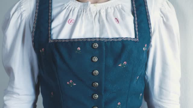 Top part of a traditional antique Austrian dirndl dress with embroidered flowers along the bodice, Salzburg, Austria