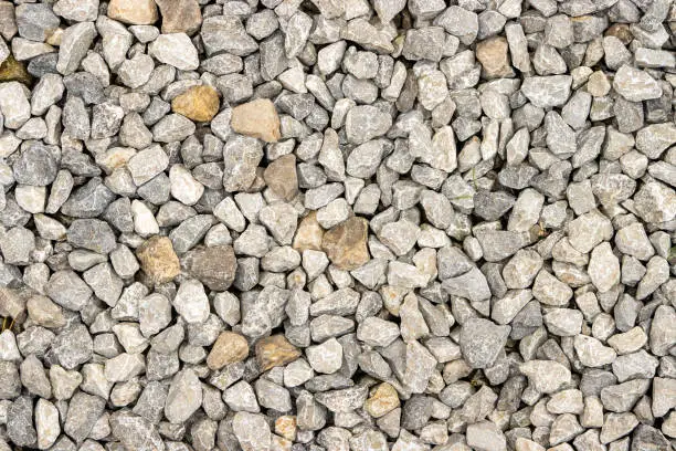 Shallow focus on small gravel, creating a unique road texture pattern.