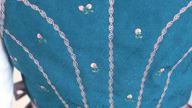 Pink floral pattern embroidery on the top of a traditional antique Austrian dirndl party dress, Salzburg, Austria