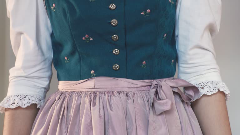 Middle part of a traditional antique Austrian dirndl dress with pink apron and embroidery on the bodice, Salzburg, Austria