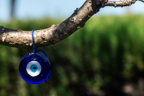 istock a blue evil eye hanging on a branch of a tree 1912109825