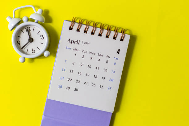 istock Desk calendar for April 2024 and clock on a yellow background. 1912113490