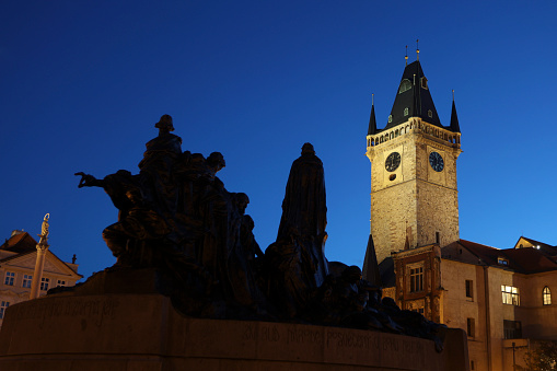 Old Town Hall and the Jan Hus memorial at the Old Town Square at night in Prague, Czech Republic.
