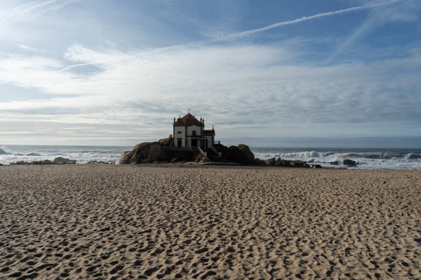 istock White chapel built on the rock at the beach. 1912176297