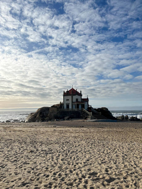 istock White chapel built on the rock at the beach. 1912176298
