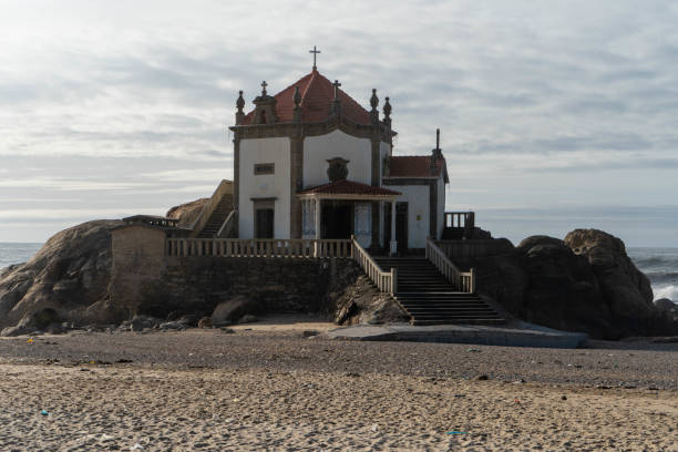 istock White chapel built on the rock at the beach. 1912176299