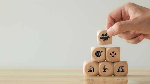 istock Business teamwork and partnerships concept. Hand putting hand shaking which print screen on wooden cube block. Business collaboration strategies, agreement, deal and finance and investment. 1912215647