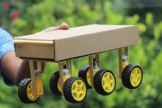 istock Robotic car that can be controlled by a smartphone and having a six wheel drive system held in the hand 1912219287
