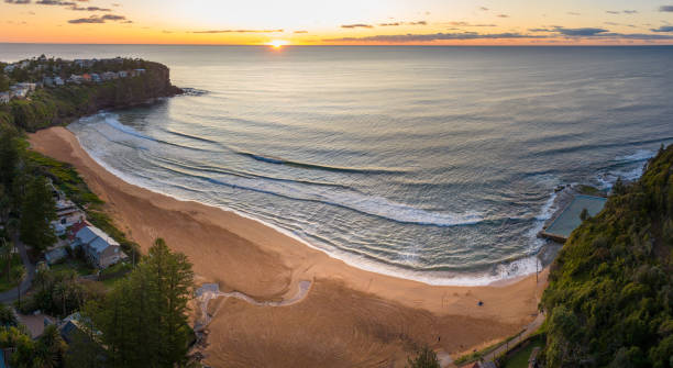 istock the sun is setting behind the beach and oceanfronts 1912250643