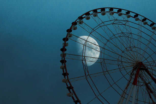 istock Ferris wheel in a playground with moon background. 1912251713