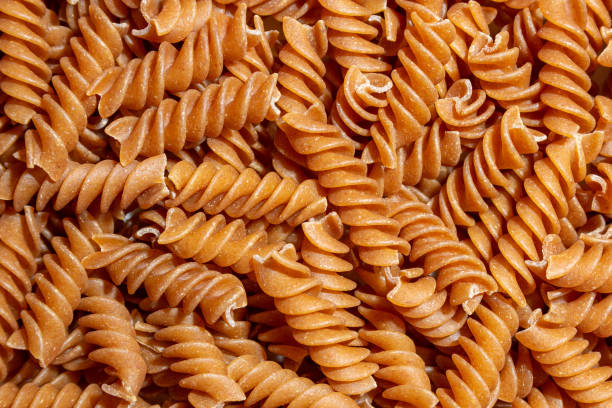 istock Uncooked Whole Grain Fusilli Pasta Background 1912277857