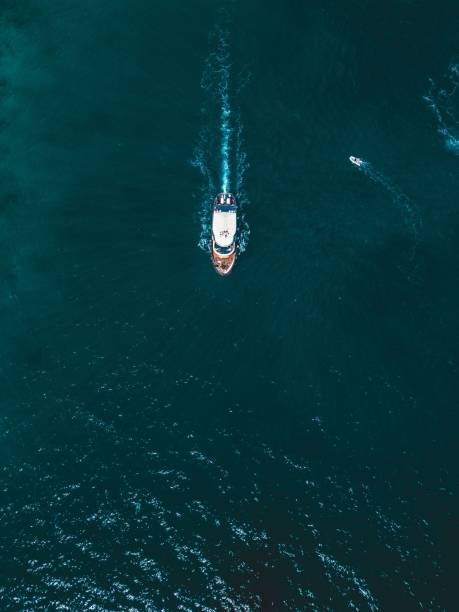 istock a small boat in the water on a blue sky day 1912278935