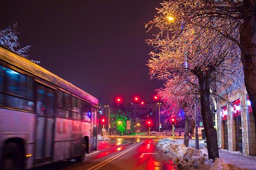 View of Varna city snow covered streets on cold winter evening,city bus passing, Bulgaria