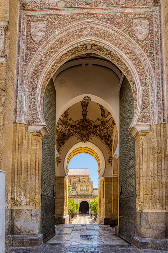 Cordoba, Spain - August 30, 2023: Exterior moorish arched entry to the Mezquita Cathedral, originally part of the Great Mosque of Cordoba
