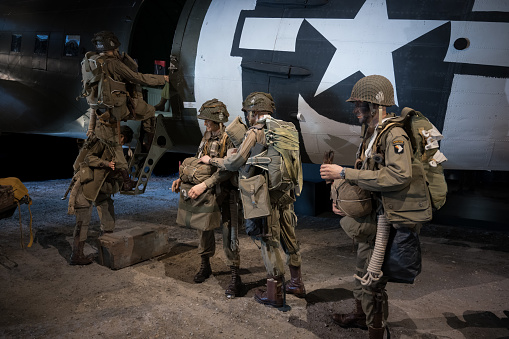 Saint Mere Eglise, France – October 14, 2023: American soldiers of the airborne parachute division boarding the plane to undertake a mission in Normandy during the Second World War