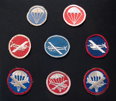 Saint Mere Eglise, France – October 14, 2023: Set of clothing patches insignia airborne gliders paratroopers artillery