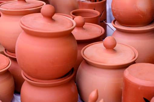 Collection of images with unglazed handmade pottery pot made of red clay. Teracota vase. Pottery basics. Sale in Pune, India, handcraft fair.