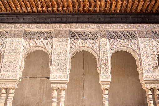 A view of an ancient palace at sunset at the Alhambra in Spain. A perfect mirrored reflection.