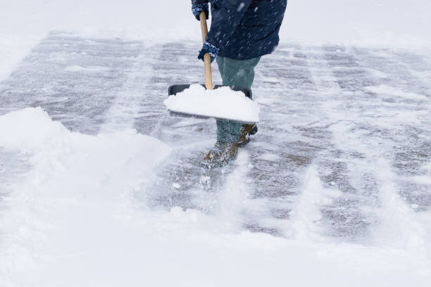 istock an unrecognizable man cleans snow with a shovel in a snowfall 1912447039